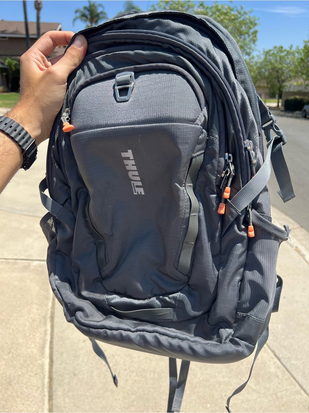Thule Gray Backpack with Orange Pull Tabs